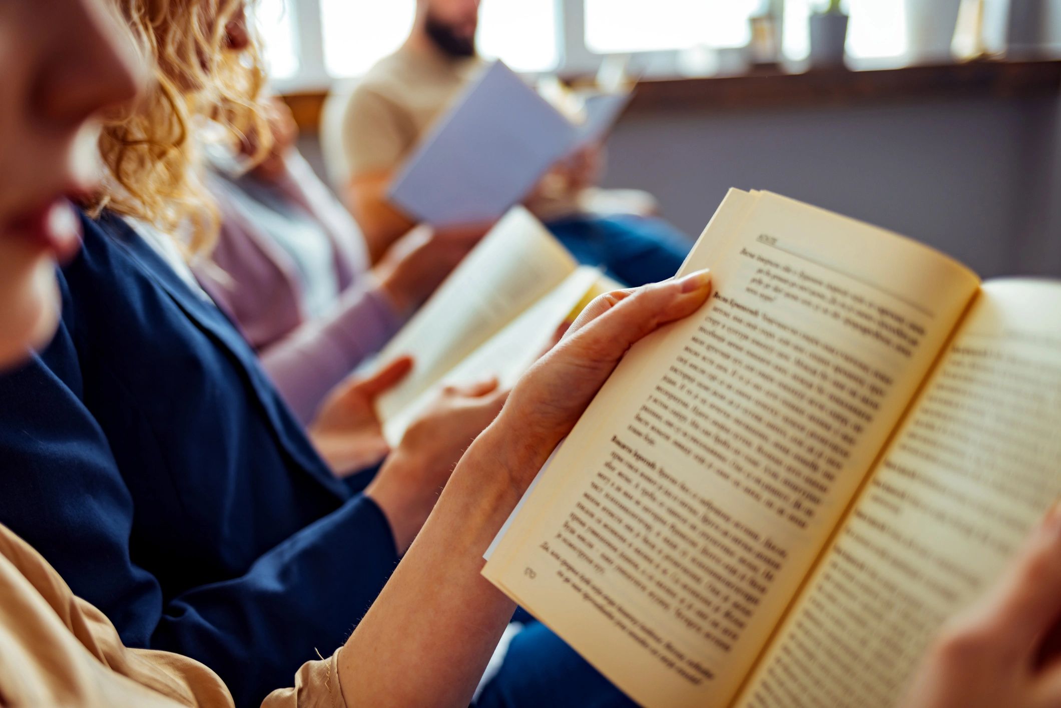 Students discussing books together in a library