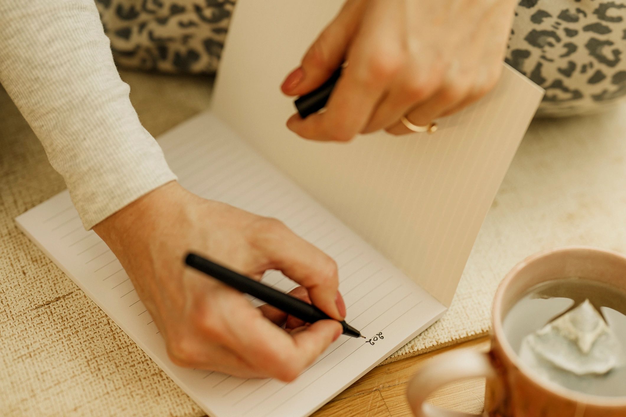 Author writing notes at a desk