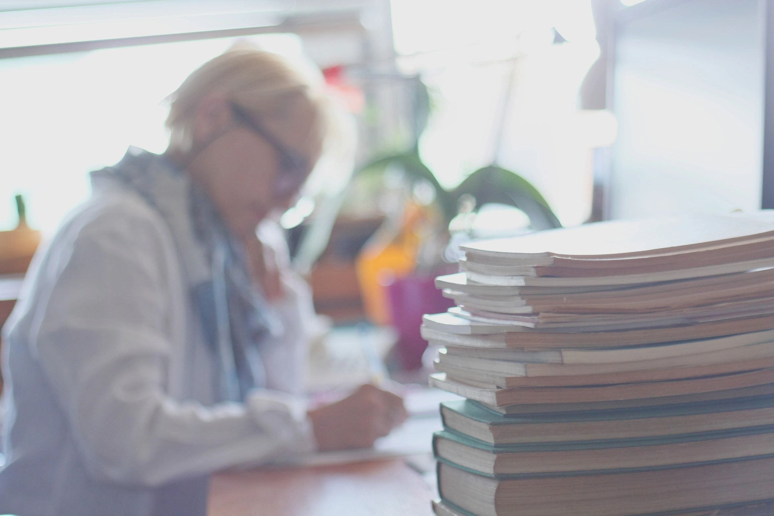 Author working at a desk surrounded by books