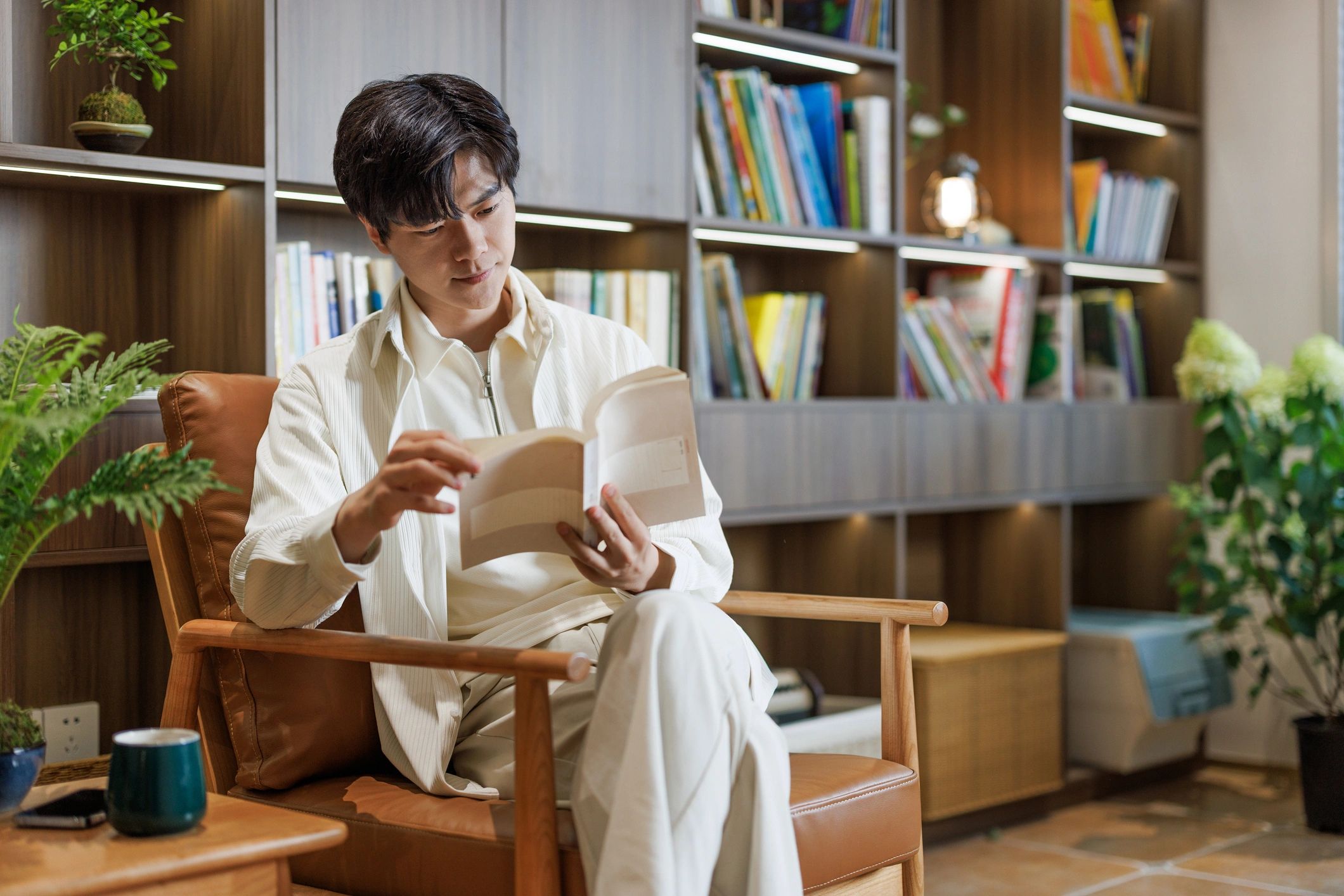 Person reading a book at home