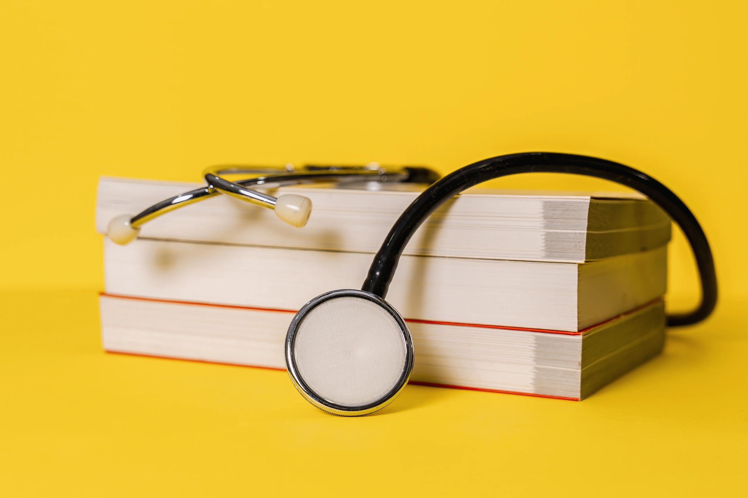 Stethoscope resting on stacked textbooks