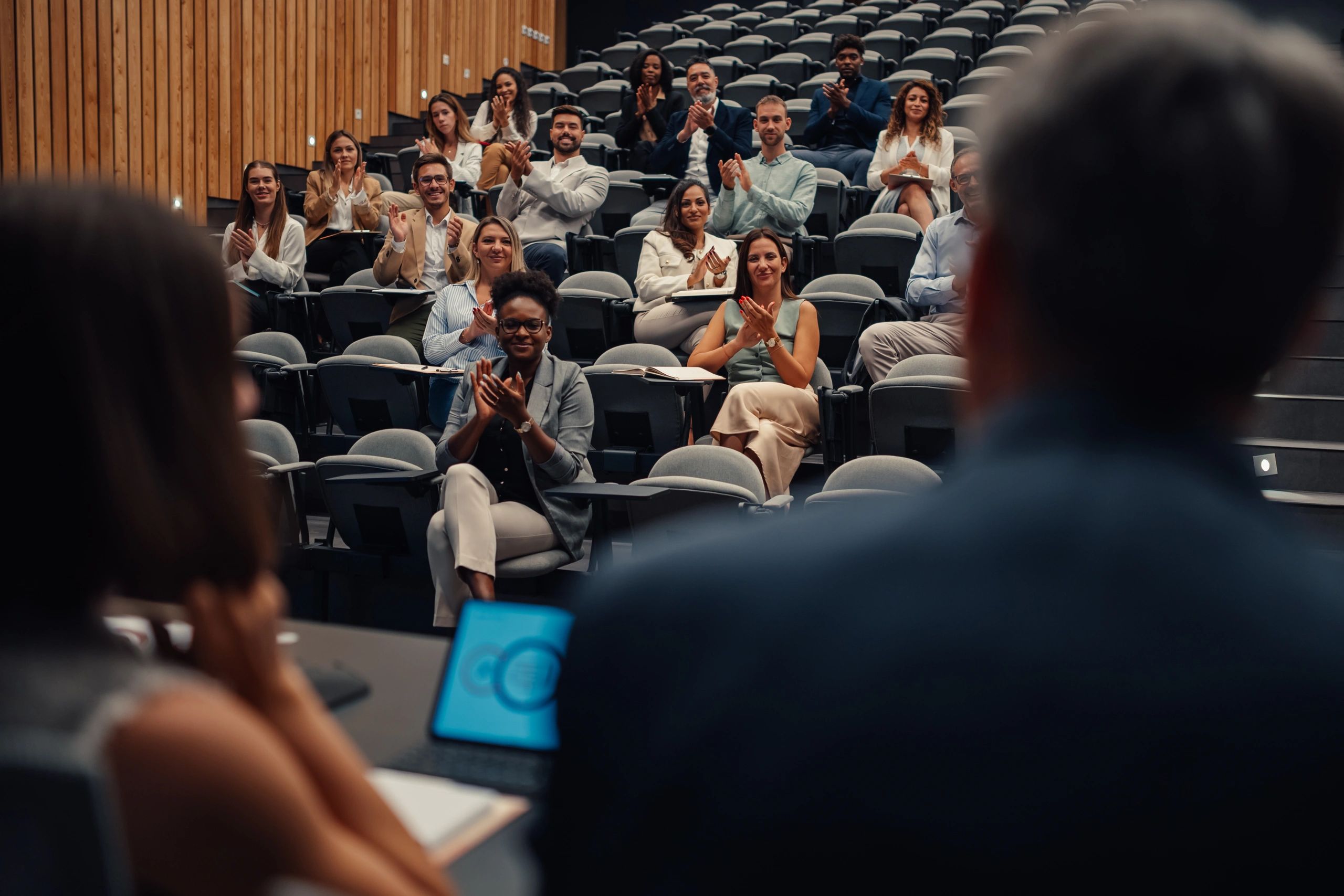 Audience attending and applauding an author presentation